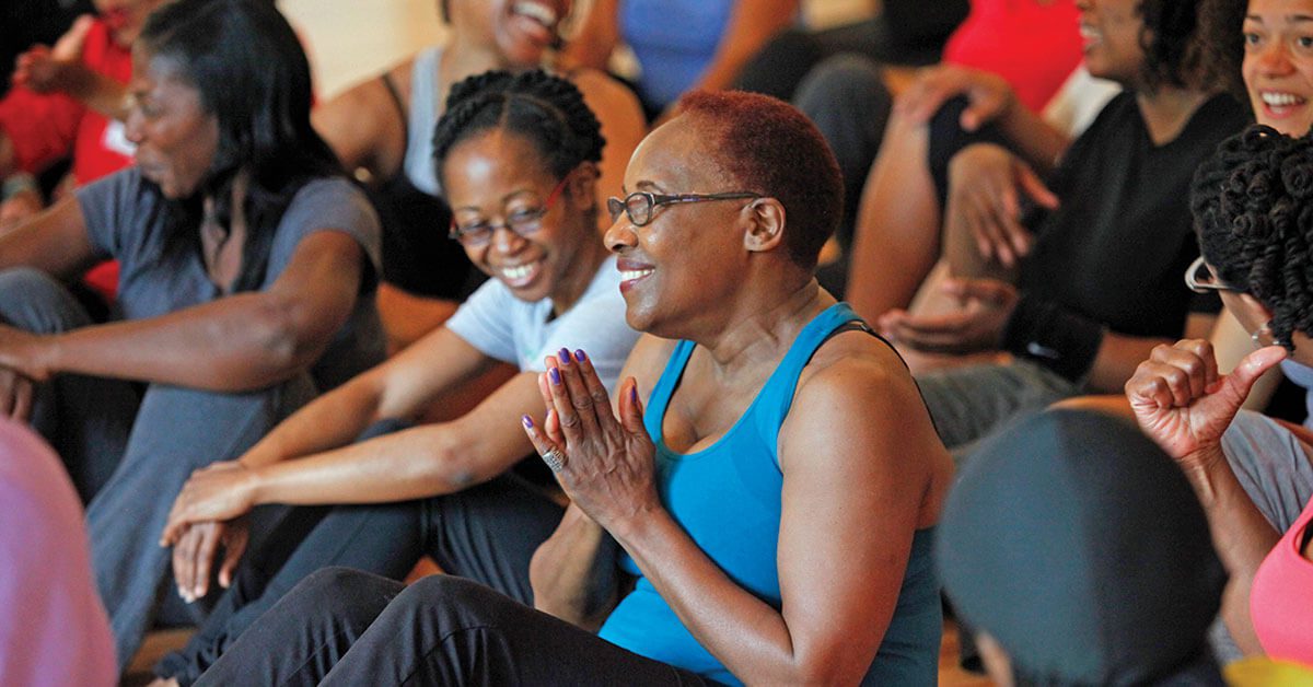 A Woman in a Blue Tank Top Sitting in a Crowd