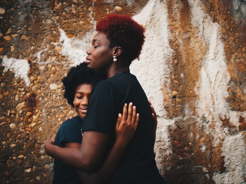 Two Women of African Origin Hugging Copy